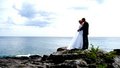 A bride and groom look out at the water at Bluefin Bay resort