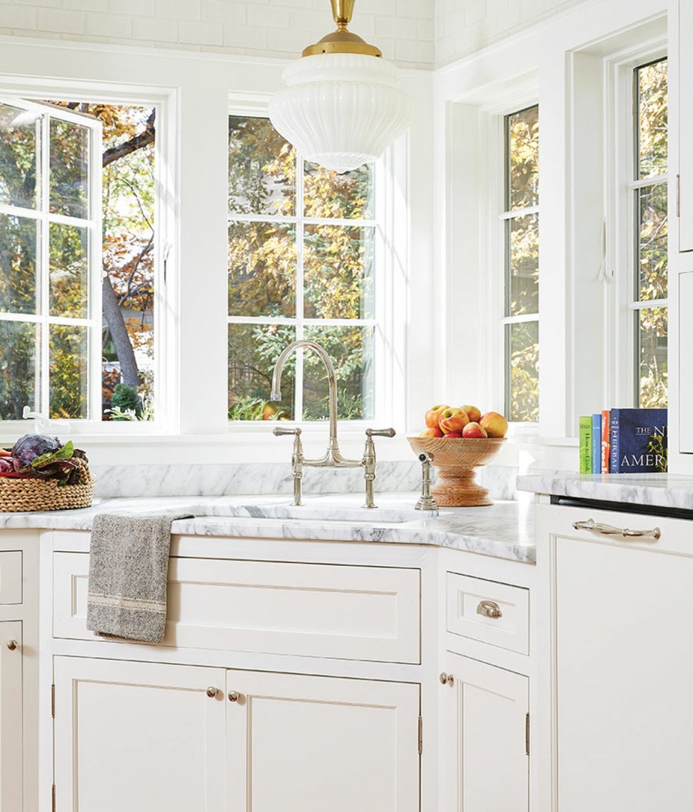 Kitchen with white cabinets and marble countertop
